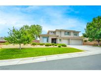 Two-story house with landscaped lawn and a three-car garage at 18 Wade Hampton Trl, Henderson, NV 89052