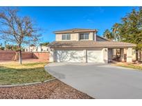 Two-story house with a three-car garage and landscaped front yard at 2683 Regency Cove Ct, Las Vegas, NV 89121