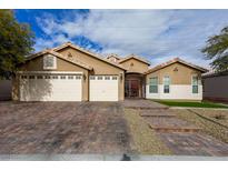 Inviting home exterior with three-car garage, paved driveway, and landscaped front yard at 3508 Pantego Ave, North Las Vegas, NV 89031