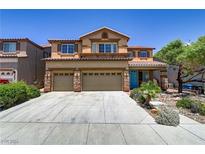 Two-story house with three-car garage and landscaped yard at 116 Jay Porter Ave, Henderson, NV 89002