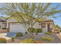 House exterior with attached garage and desert landscaping at 2347 Tranquil Moon St, Henderson, NV 89044