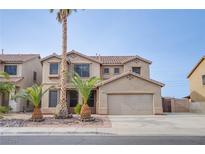 Two-story house with a large garage and palm trees in the front yard at 227 Palmarosa St, Henderson, NV 89015