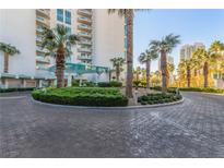 Luxury highrise building with palm trees and circular driveway at 322 Karen Ave # 505, Las Vegas, NV 89109