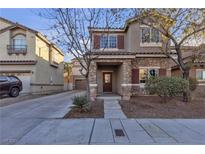 Two-story house with stone accents and a landscaped yard at 1321 Robbers Roost Ave, Henderson, NV 89012