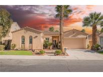 Beautiful single-story home with a landscaped front yard, driveway, and two-car garage at 2824 Evening Rock St, Las Vegas, NV 89135