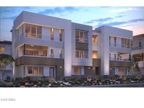 Modern three-story townhome with two-car garage and landscaped front yard at 3355 Roebling Opal Way, Henderson, NV 89044