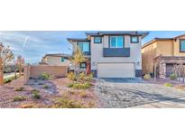 Two-story house with a landscaped yard and brick driveway at 341 Night Dove St, Henderson, NV 89011