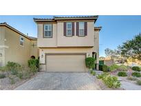 Two-story house with tan siding, brown shutters, and a paved driveway at 9303 Ettrick Ct, Las Vegas, NV 89178