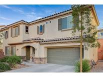 Two-story house with a neutral color scheme and a two-car garage at 9715 Aleutian St, Las Vegas, NV 89178