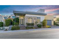 Modern home exterior with stone accents, landscaping, and a welcoming entry at 2223 Summit Mesa Ln, Henderson, NV 89052