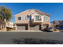 Tan two-story home with three-car garage and balcony at 2050 Scanlon Ferry Ct # 103, Las Vegas, NV 89156