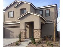 Two-story house with stone accents and landscaped yard at 9144 Sea Mink Ave, Las Vegas, NV 89149