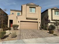 Two-story house with a tan exterior, two-car garage, and landscaped front yard at 4628 Wyncrest Ave, Las Vegas, NV 89115