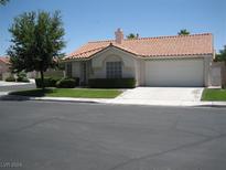 Single-story house with tile roof and attached garage. Landscaped front yard at 7955 Canto Ave, Las Vegas, NV 89147