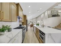 Renovated kitchen, featuring modern cabinetry, quartz countertops, and stainless steel appliances at 293 Helmsdale Dr, Henderson, NV 89014