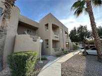 Tan two-story building with walkway, landscaping, and parking at 2191 Bay Club Dr # 202, Laughlin, NV 89029