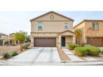 Two-story house with brown garage door and landscaping at 4959 Quest Tribe St, Las Vegas, NV 89122