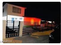 Updated single story home with a modern front gate and landscape at 5060 Hallet Dr, Las Vegas, NV 89122