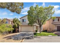 Two-story house with attached garage and landscaped yard at 9893 Canyon Peak Dr, Las Vegas, NV 89147