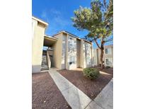 Exterior view of a two-story apartment building with walkways, stairs, and landscaping at 7300 Pirates Cove Rd # 1065, Las Vegas, NV 89145