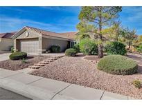 Charming single-story home with a landscaped front yard and attached two-car garage at 2605 High Range Dr, Las Vegas, NV 89134