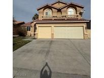 Two-story house with a three-car garage and a large driveway at 4900 Quinlan Ave, Las Vegas, NV 89130