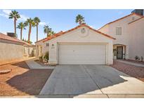 Single-story house with a two-car garage and desert landscaping at 6653 Lund Dr, Las Vegas, NV 89108