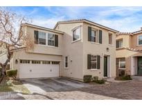 Two-story home with attached garage, paved driveway, and landscaped front yard at 8331 Lower Trailhead Ave, Las Vegas, NV 89113