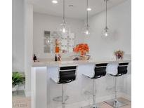 Modern wet bar with stylish pendant lights, white countertop, and bar seating at 102 Appia Pl, Henderson, NV 89011