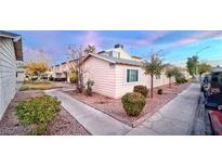 Attractive exterior of a light yellow house with landscaping and walkway at 4950 Larkspur St, Las Vegas, NV 89120