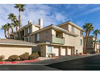 Exterior view of a three-story condo building with attached garages and palm trees at 7163 S Durango Dr # 113, Las Vegas, NV 89113