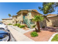 Tan two-story building with stairs and landscaping at 338 Jett St # 101, Las Vegas, NV 89145