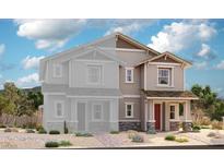 Exterior elevation of a two-story home with a red front door, stone accents, and desert landscaping at 580 Celebratory Pl, Henderson, NV 89011