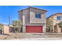 Two-story home with a red garage door, desert landscaping, and a paved driveway at 5758 Sunset Sedona St # Lot 16, North Las Vegas, NV 89081