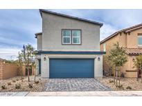 Two-story home with blue garage door, paved driveway, and desert landscaping at 594 Juniper Rock St # Lot 59, North Las Vegas, NV 89081