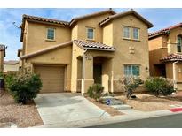 Two-story home with a tiled roof, attached garage, and landscaped front yard at 8381 Transvaal Blue St, Las Vegas, NV 89139