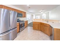 Modern kitchen features stainless steel appliances and light wood cabinets at 2287 Dakota Sky Ct, Henderson, NV 89052