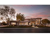 Modern luxury home at dusk with landscaped yard and driveway at 633 Saint Croix St, Henderson, NV 89012