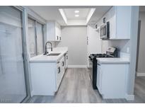 Modern kitchen with white cabinets, quartz countertops, and stainless steel appliances at 1440 Vegas Valley Dr # 3, Las Vegas, NV 89169