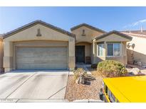 One-story home with attached two-car garage and desert landscaping at 3329 Glacial Lake St, Las Vegas, NV 89122