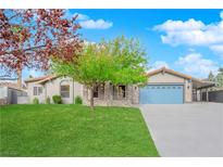 Single-story home with a landscaped lawn, attached garage, and inviting curb appeal at 3159 Vistoso Cir, Henderson, NV 89014