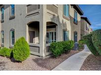 Exterior view of a two-story home with a walkway, landscaping, and AC unit at 3480 Cactus Shadow St # 101, Las Vegas, NV 89129