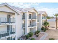 Exterior view of a three-story condo building with balconies and a landscaped walkway at 3550 Bay Sands Dr # 3061, Laughlin, NV 89029