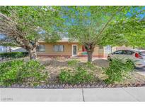 One-story home with a front yard, trees, and a paved driveway at 6109 Empire Cir, Las Vegas, NV 89107