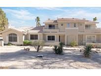 Two-story townhome with Spanish tile roof, desert landscaping, and two-car garage at 2157 Camel Mesa Dr, Laughlin, NV 89029