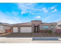 Single-story home with three-car garage, neutral color scheme, and landscaped yard at 5733 Granite Landing Ct, Las Vegas, NV 89131