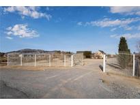 Country home gated entrance with long driveway at 170 Story Ave, Pahrump, NV 89060