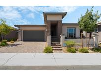 Modern single-story home with a two-car garage and landscaped front yard at 421 Point Sur Ave, Las Vegas, NV 89138