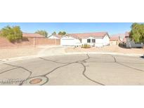 Single-story house with attached garage and driveway, surrounded by a short wall at 3134 Flower Garden Ct, North Las Vegas, NV 89031