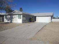 Single story home with attached garage and landscaped yard at 5450 Black Rock Way, Las Vegas, NV 89110